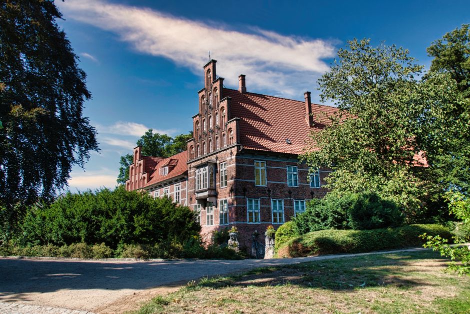 Explore the medieval architecture of Bergedorf Castle nestled in lush greenery in Hamburg.